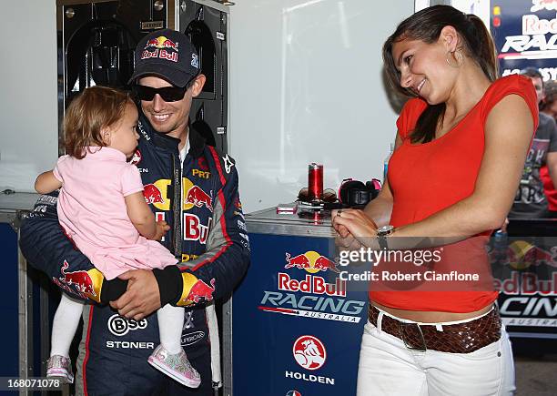 Casey Stoner driver of the Red Bull Pirtek Holden is seen with his wife Adriana and baby daughter Alessandra Maria prior to round two of the V8...