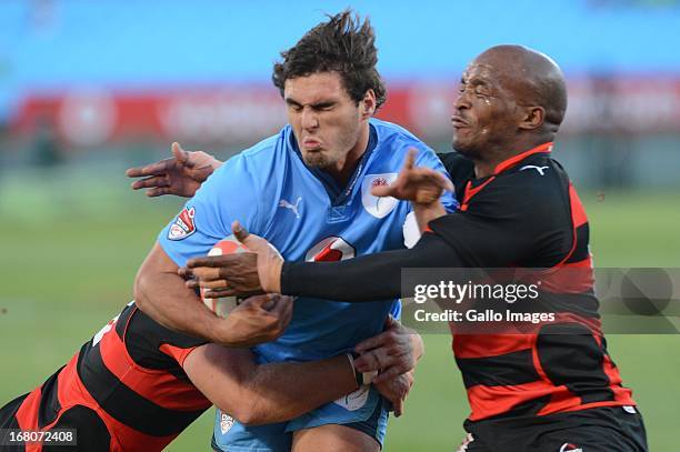 Wayne Stevens and Siyabonda Mangweni of Eastern Province Kings tackle Dries Swanepoel of Blue Bulls during the Vodacom Cup Quarter Final match...