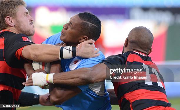 Sampie Mastriet of Blue Bulls tackled by Marcello Sampson of Eastern Province Kings during the Vodacom Cup Quarter Final match between Vodacom Blue...