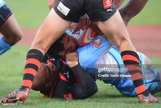 Dries Swanepoel of Blue Bulls tackled by Siyabonda Mangweni of Eastern Province Kings during the Vodacom Cup Quarter Final match between Vodacom Blue...