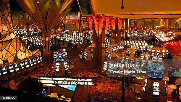 Gamblers play on some of the more than 6,000 slot machines at Mohegan Sun casino November 20, 2002 in Uncasville, Connecticut. The casino is owned...