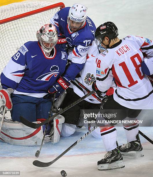 Austria's forward Thomas Koch attacks the net of French goalkeeper Cristobal Huet during the preliminary round match France vs Austria at the IIHF...