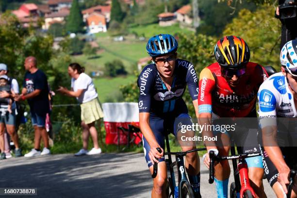 Damiano Caruso of Italy and and Team Bahrain - Victorious, Max Poole of The United Kingdom and Team DSM - firmenich compete in the breakaway climbing...