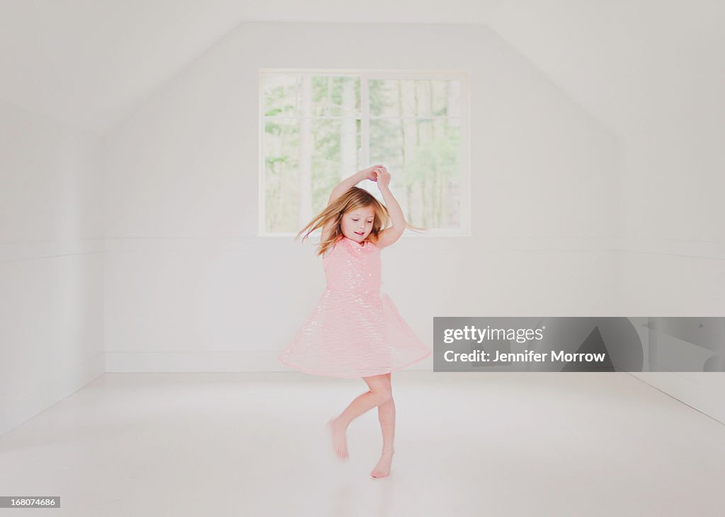 Girl dancing in a pink dress