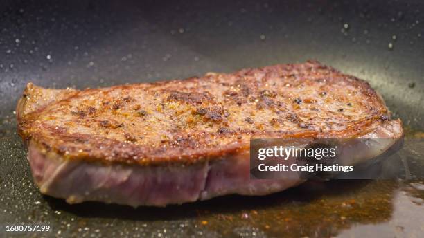 steak sizzling in frying pan with oil - at home not restaurant - carnivora stock pictures, royalty-free photos & images