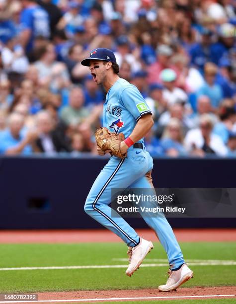 Ernie Clement of the Toronto Blue Jays reacts after picking off Jacob Young of the Washington Nationals at second base in the fifth inning at Rogers...