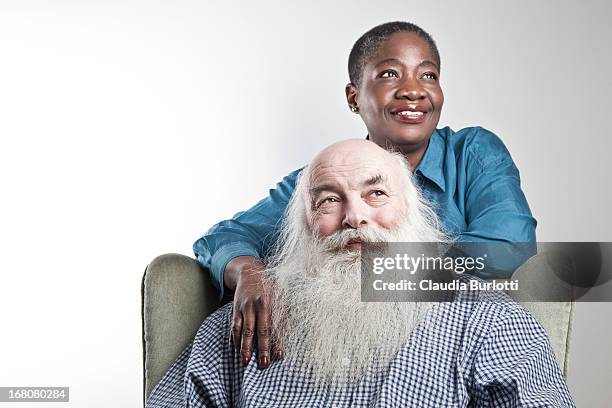 happy mixed race couple - mixed race man standing studio stockfoto's en -beelden