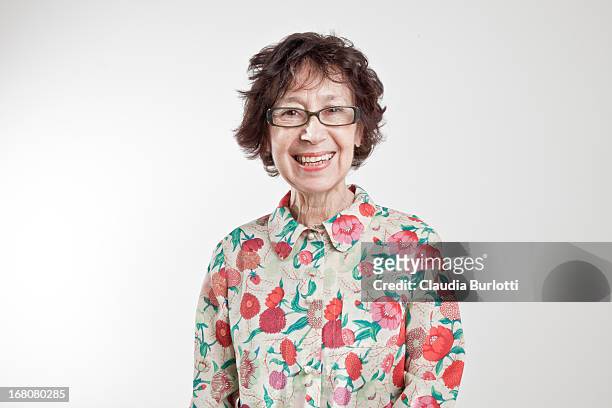 happy old lady in colorful shirt - old person on white background stockfoto's en -beelden