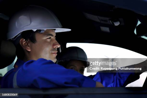 engineer in car while he's leaving the construction site. - automobile production at the seat factory stock pictures, royalty-free photos & images