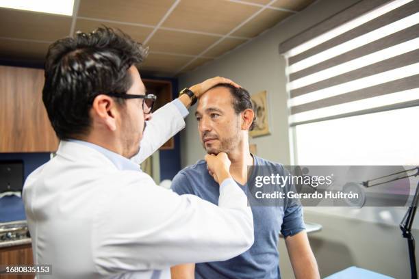 neurosurgeon attending to male patient - neurosurgery stock pictures, royalty-free photos & images