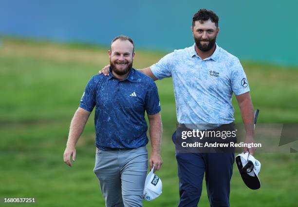 Tyrrell Hatton of England and Jon Rahm of Spain embrace on the 18th green during Day One of the BMW PGA Championship at Wentworth Golf Club on...