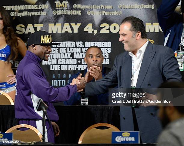 Floyd Mayweather Jr. Is greeted on stage by CEO of Golden Boy Promotions Richard Schaefer during the news conference after the Floyd Mayweather Jr....