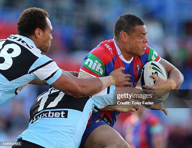 Timana Tahu of the Knights tries to break the Sharks defence during the round eight NRL match between the Newcastle Knights and the Cronulla Sharks...