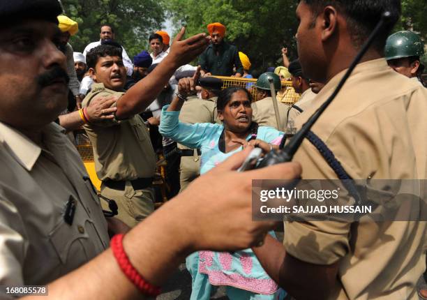 An Indian Sikh woman shouts anti-government slogans during a demonstration against the acquittal of Congress politician Sajjan Kumar, in New Delhi on...