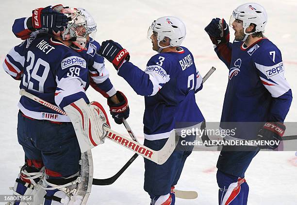 French players congratulate their goalkeeper Cristobal Huet , as they defeated team Austria 3-1 at the preliminary round match France vs Austria at...