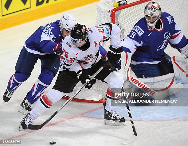 Austria's forward Thomas Vanek vies with French defender Kevin Hecquefeuille in front of the net of French goalkeeper Cristobal Huet during the...