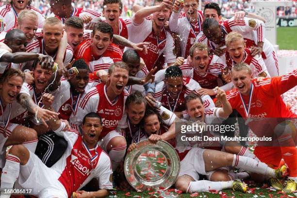 Ajax captain, Siem De Jong leads his teams celebrations with the Eredivisie Championship trophy after the match between Ajax and Willem II Tilburg at...