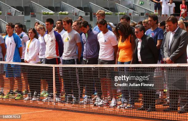 Tennis players including Novak Djokovic, Andy Murray, Roger Federer, Rafael Nadal and Serena Williams observe a moment of silence for Brad Drewett...