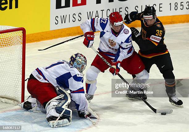 Yannic Seidenberg of Germany and Yevgeni Medvedev of Russia battle for the puck during the IIHF World Championship group H match between Germany and...