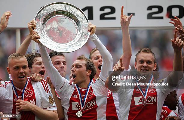 Ajax players, Kolbeinn Sigthorsson, Christian Eriksen and captain, Siem De Jong lead celebrations with the Eredivisie Championship trophy after the...