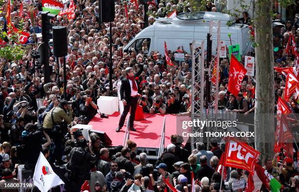 Jean-Luc Melenchon , leader of Front de Gauche left wing party raises his fist as he gives a speech on stage on May 5, 2013 in Paris, during a...