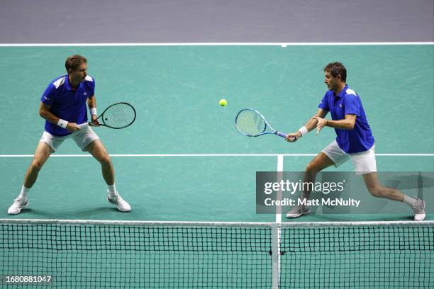 Edouard Roger-Vasselin Team France plays a volley alongside doubles partner Nicolas Mahut during the Davis Cup Finals Group Stage match between...