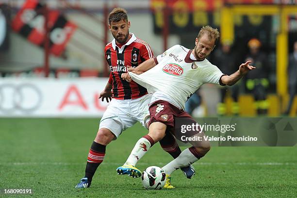 Migjen Basha of Torino FC has his shirt pulled by Antonio Nocerino of AC Milan during the Serie A match between AC Milan and Torino FC at San Siro...