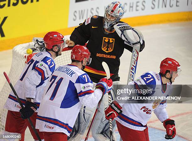 Germany's goalie Dennis Endras looks at Russia's players as they scored past him during the preliminary round match Germany vs Russia of the IIHF...