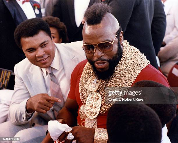 Former boxer Muhammad Ali and celebrity actor Mr. T talk to fans before the IBF Heavyweight Title fight with Michael Spinks and Larry Holmes on...
