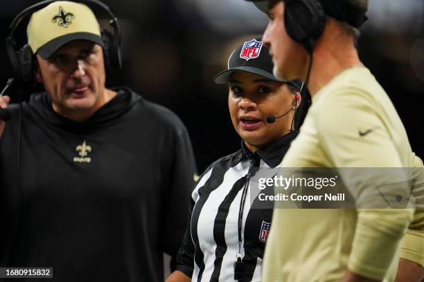 Line judge Maia Chaka talks with New Orleans Saints coaches at Caesars Superdome on September 10, 2023 in New Orleans, Louisiana.