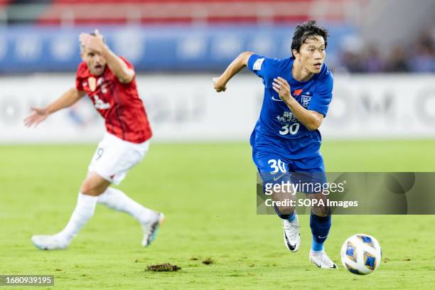 Xie Pengfei of Wuhan Three Towns advances the ball during the AFC champions league group J match between China's Wuhan Three Towns and Japan's Urawa...