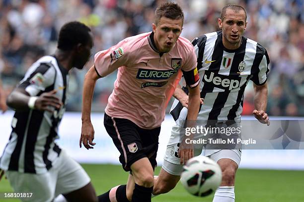 Giorgio Chiellini of Juventus and Josip Ilicic of Palermo pursue the ball the Serie A match between Juventus and US Citta di Palermo at Juventus...