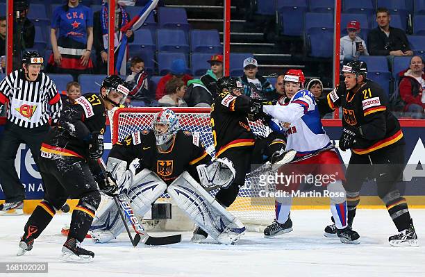 Yannic Seidenberg of Germany battles for position with Alexander Popov of Russia during the IIHF World Championship group H match between Germany and...