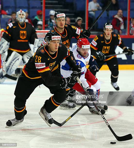 Frank Mauer of Germany and Alexander Radulov of Russia battle for the puck during the IIHF World Championship group H match between Germany and...