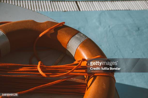 orange lifebuoy over blue background - mediterranean culture stock pictures, royalty-free photos & images