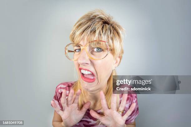 funny fisheye woman with blond mullet expressing disgust - mullet haircut woman stock pictures, royalty-free photos & images