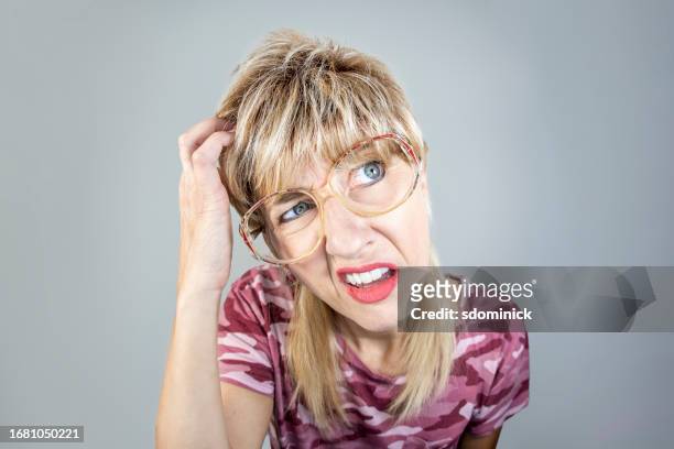 funny fisheye woman with mullet looking dumb as she scratches her head - ignorance stock pictures, royalty-free photos & images