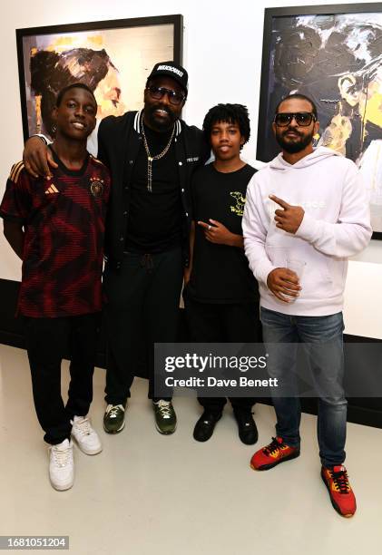 Guest, Dereck Chisora, guest and Noel Clarke attend the "Radiant Resilience" debut exhibition from Zara Muse at Quantus Gallery Shoreditch on...