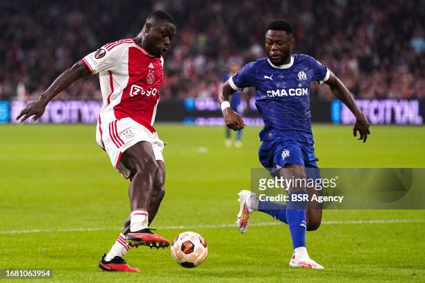 Brian Brobbey of AFC Ajax battles for possession with Chancel Mbemba of Olympique de Marseille during the UEFA Champions League Group B match between...