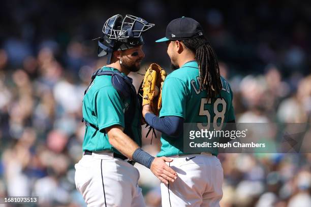 Cal Raleigh and Luis Castillo of the Seattle Mariners talk during the game against the Los Angeles Angels at T-Mobile Park on September 13, 2023 in...