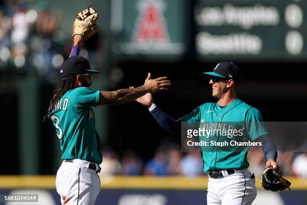 Crawford and Dylan Moore of the Seattle Mariners celebrate their 3-2 win against the Los Angeles Angels at T-Mobile Park on September 13, 2023 in...