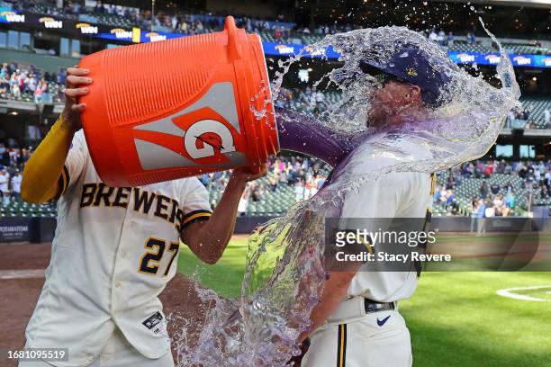 Tyrone Taylor of the Milwaukee Brewers is doused by Willy Adames following a game against the Miami Marlins at American Family Field on September 14,...