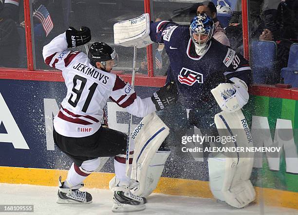 Latvia's forward Roberts Jekimovs attacks US goalkeeper Ben Bishop during the preliminary round match Latvia vs United States of the IIHF...