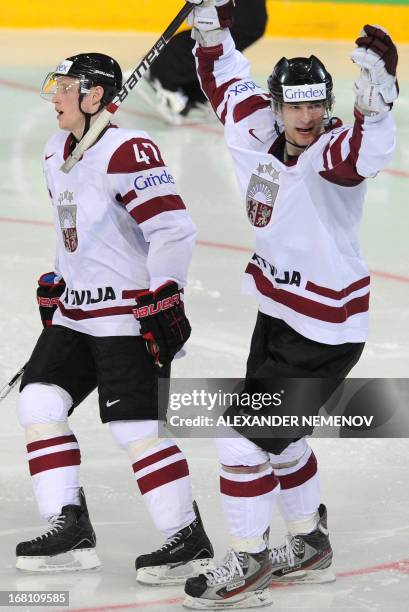 Latvia's forwards Lauris Darzins and Martins Cipulis celebrate scoring during the preliminary round match Latvia vs United States of the IIHF...