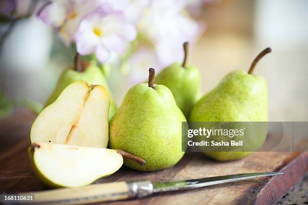 green pears on wooden board - pear use stock pictures, royalty-free photos & images