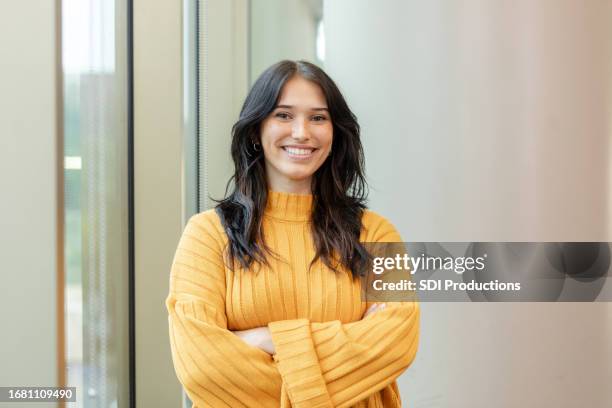 portrait of beautiful, confident young adult female university student - teacher studio portrait stock pictures, royalty-free photos & images