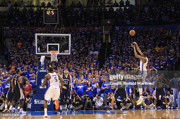 Kevin Durant of the Oklahoma City Thunder makes a three-point shot with 12.6 seconds left against the Memphis Grizzlies during Game One of the...