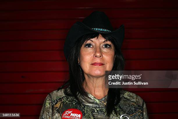 Member Becky Lou Lacock poses for a photograph during the 2013 NRA Annual Meeting and Exhibits at the George R. Brown Convention Center on May 5,...