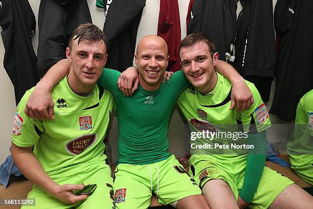 Northampton Town goal scorer Luke Guttridge celebrates with team-mates Lee Collins and John Johnson in the changing room after the npower League Two...