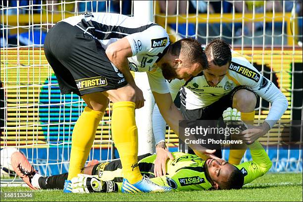 Goalkeeper Boubacar Barry of Sporting Lokeren OVL lies injured after banging his head on the goal post as he leapt to make a save during the Jupiler...